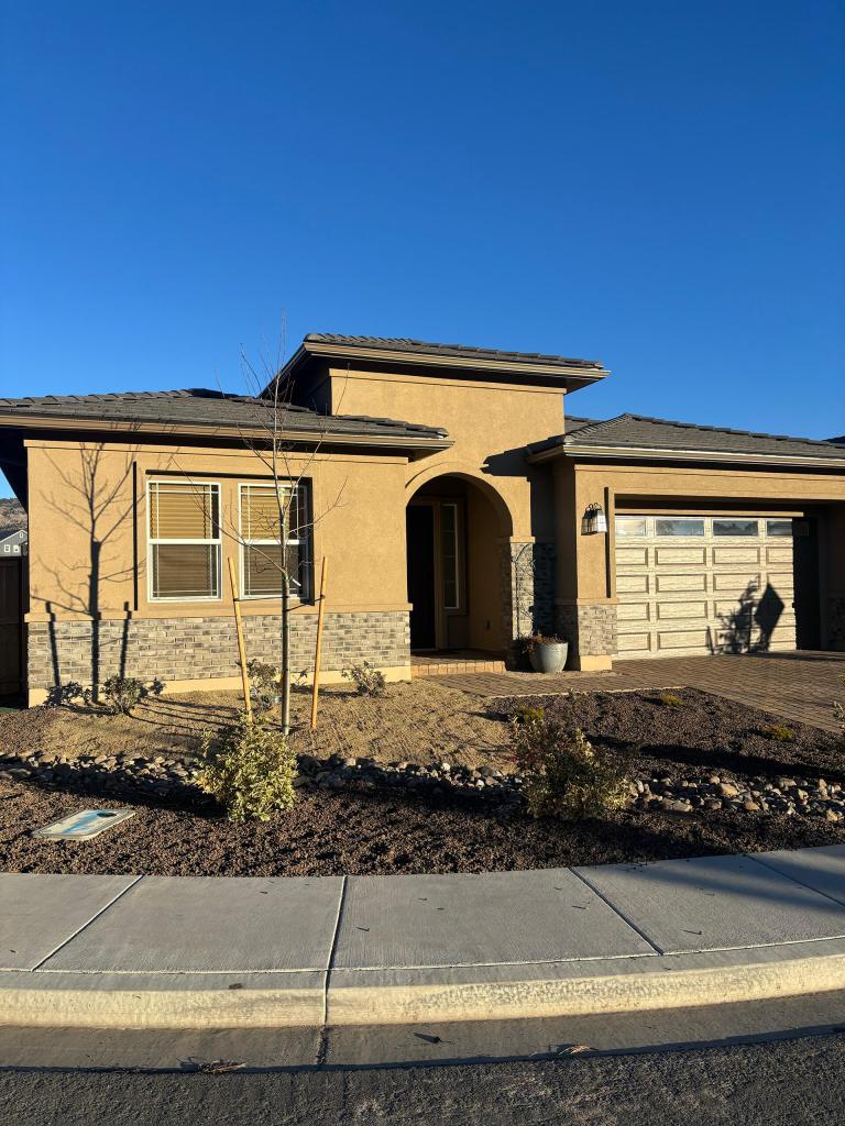 Front exterior of a single-story home with a professionally installed gutter system designed to protect the roofline from water damage.