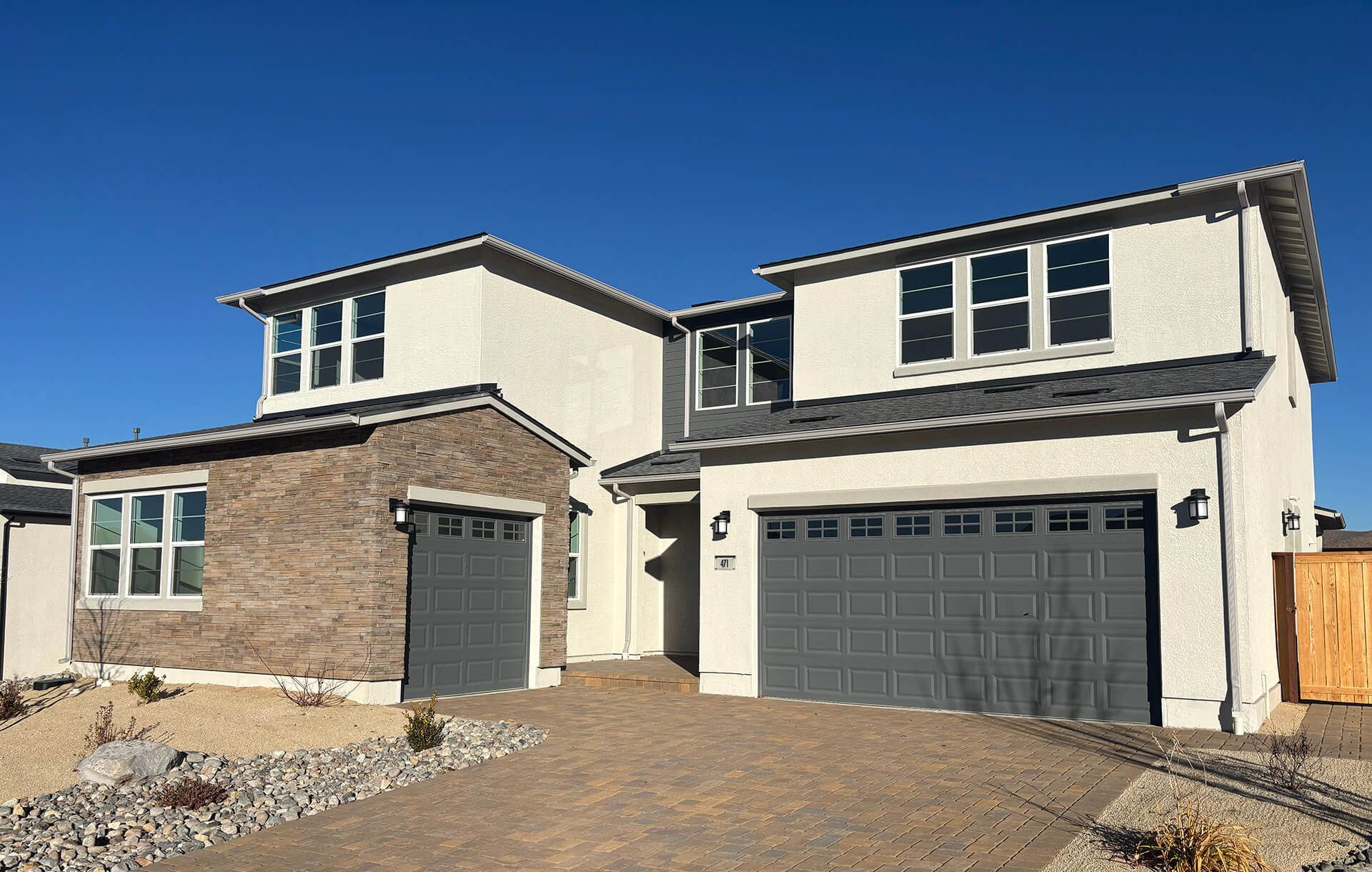Exterior of a modern two-story home with clean, seamless gutters installed by All Out Gutters to protect against water damage.